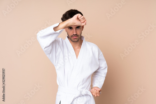 Young man over isolated background doing karate