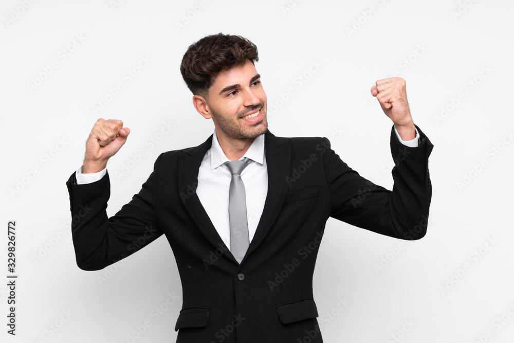 Young businessman over isolated white background celebrating a victory Young businessman over isolated white background celebrating a victory
