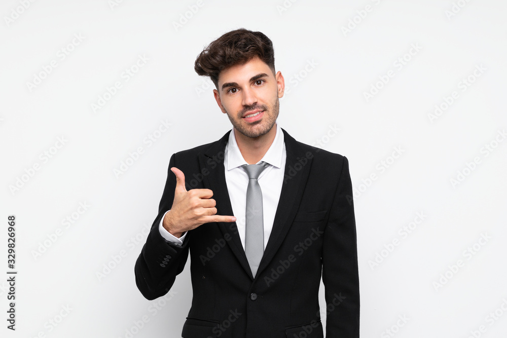 Young businessman over isolated white background making phone gesture Young businessman over isolated white background making phone gesture