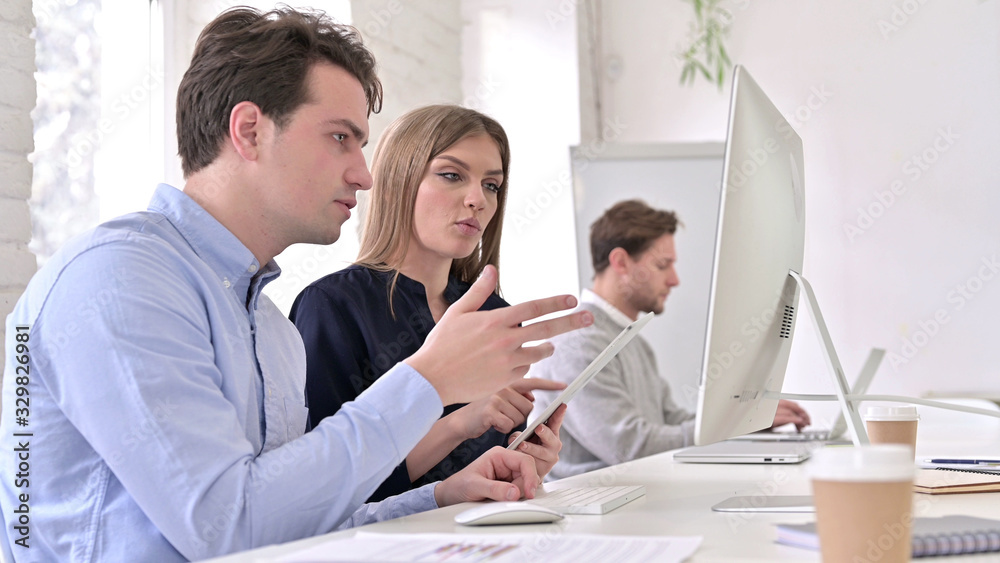 Fototapeta premium Startup Team Working on Desktop and Tablet Together