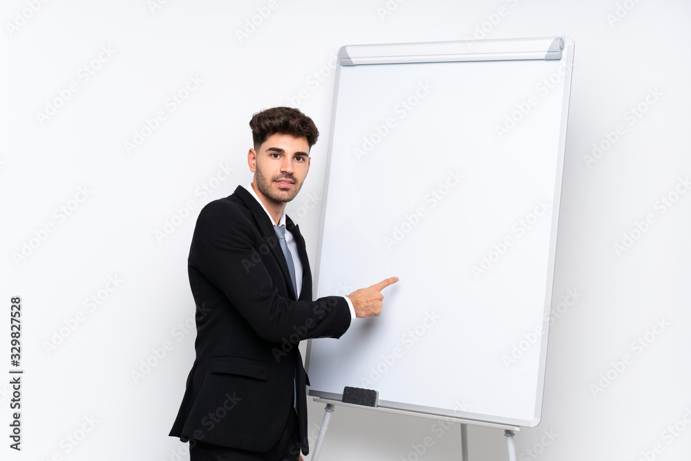 Young businessman giving a presentation on white board giving a presentation on white board Young businessman giving a presentation on white board giving a presentation on white board
