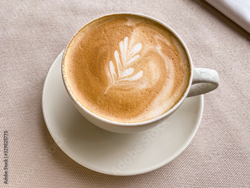 Cup of coffee on beige background.