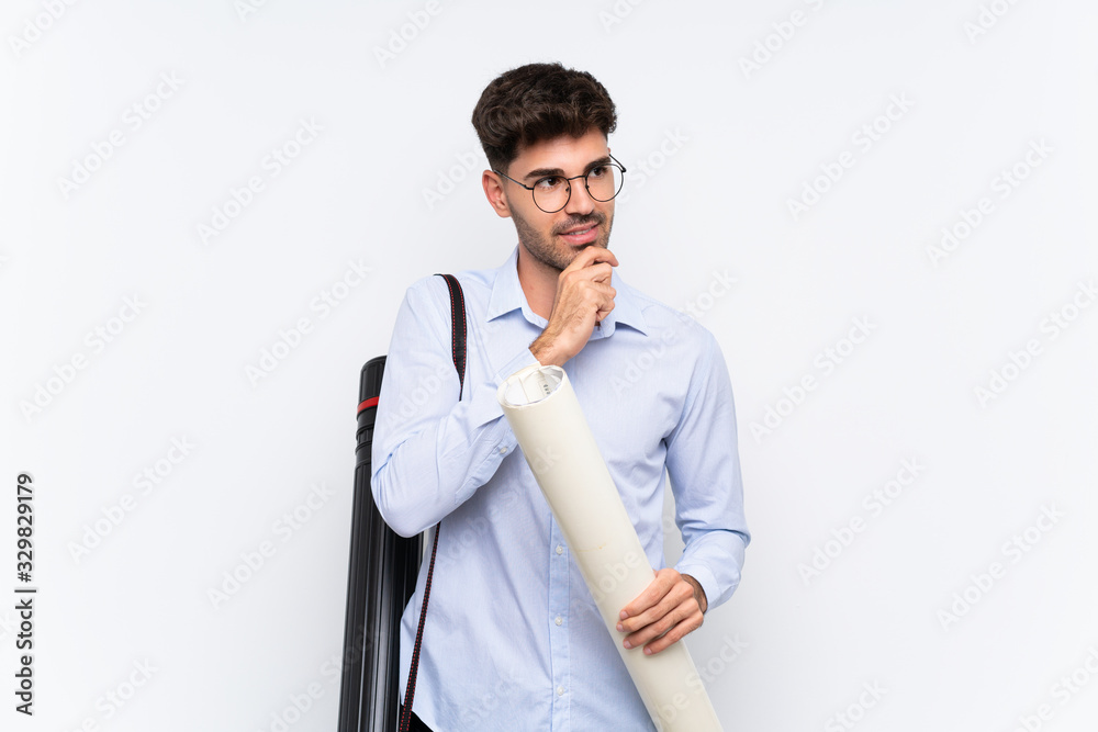 Young architect man over isolated white background thinking an idea Young architect man over isolated white background thinking an idea