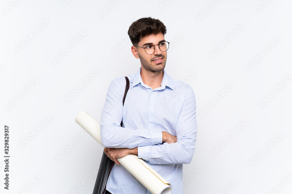 Young architect man over isolated white background looking to the side Young architect man over isolated white background looking to the side