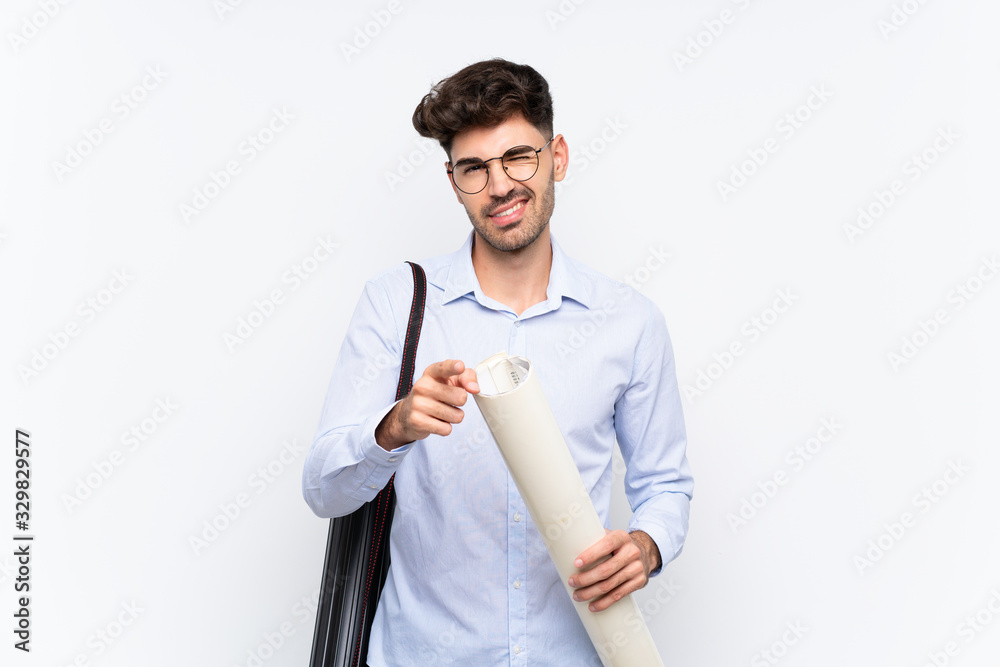 Young architect man over isolated white background points finger at you Young architect man over isolated white background points finger at you