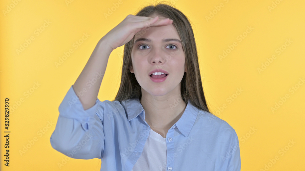 Casual Young Woman Searching for Opportunities, Yellow Background Casual Young Woman Searching for Opportunities, Yellow Background