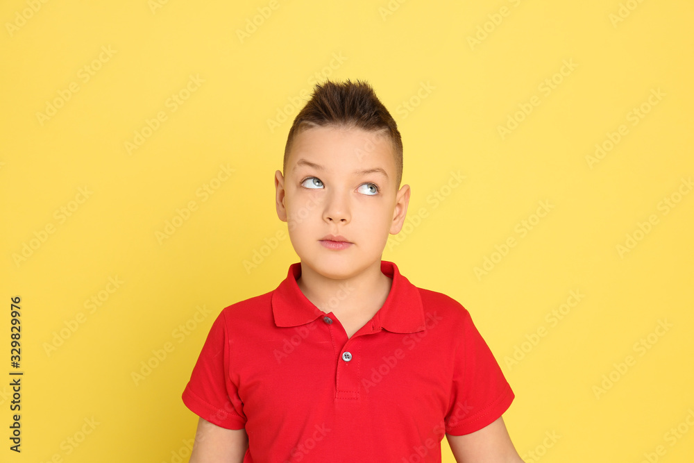 Portrait of emotional little boy on yellow background Portrait of emotional little boy on yellow background