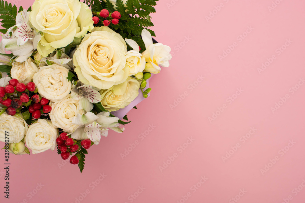 top view of bouquet of flowers on pink background