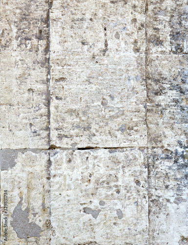 wall of yellow rectangular stones with cement, fragment of ancient architecture