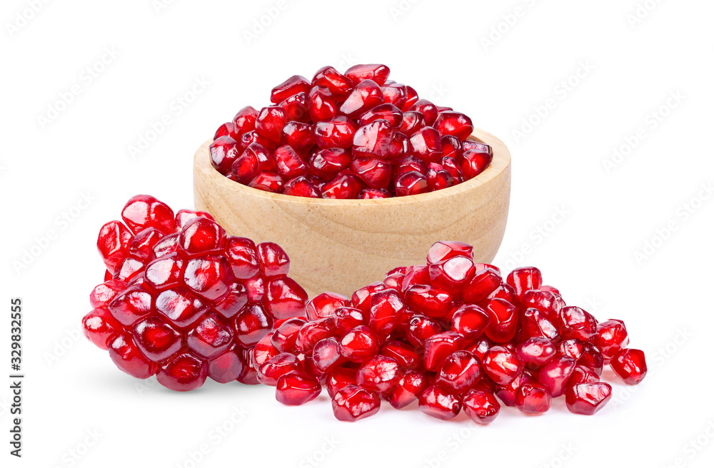 Pomegranate seeds in wood bowl isolated on white background. Pomegranate seeds in wood bowl isolated on white background.