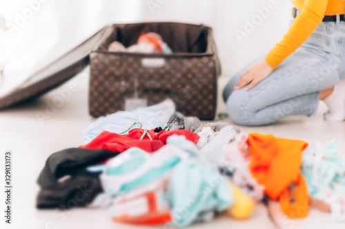 A young girl is packing her suitcase, getting ready for vacation, about to fly away