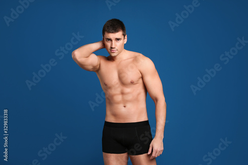 Man with sexy body on blue background © New Africa