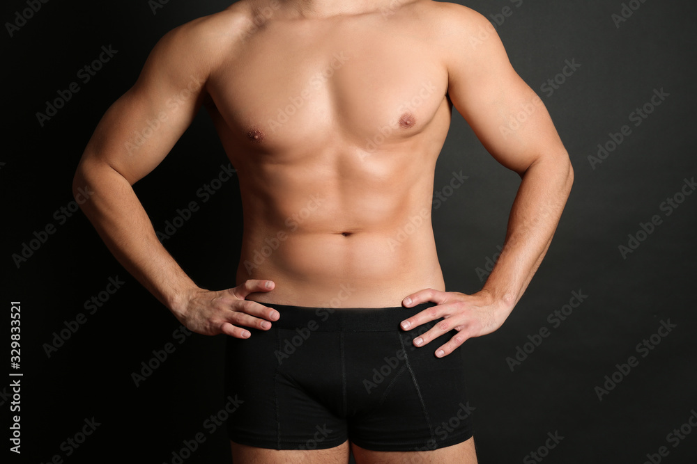 Man with sexy body on black background, closeup