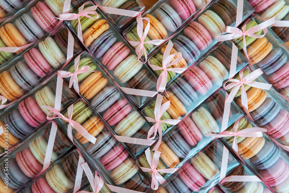 Macaroni cookies of different colors in a package with a bow, a lot of boxes with cookies in the form of texture. Macaroni cookies of different colors in a package with a bow, a lot of boxes with cookies in the form of texture.