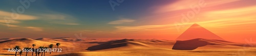 Desert panorama with pyramids at sunset