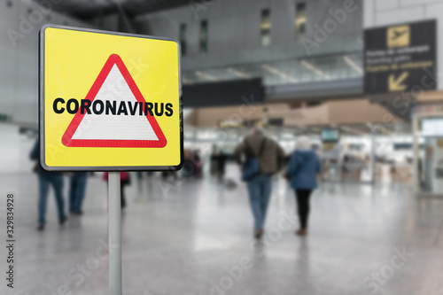 Wallpaper Mural Warning sign with text Coronavirus on a generic airport with passengers walking towards the boarding gates. Coronavirus crisis concept Torontodigital.ca