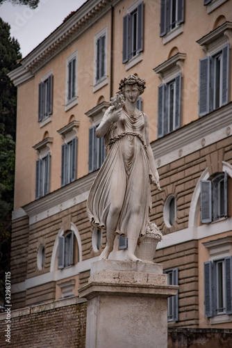 Allegorical statue in summer, Piazza del Popolo in Rome, Italy.