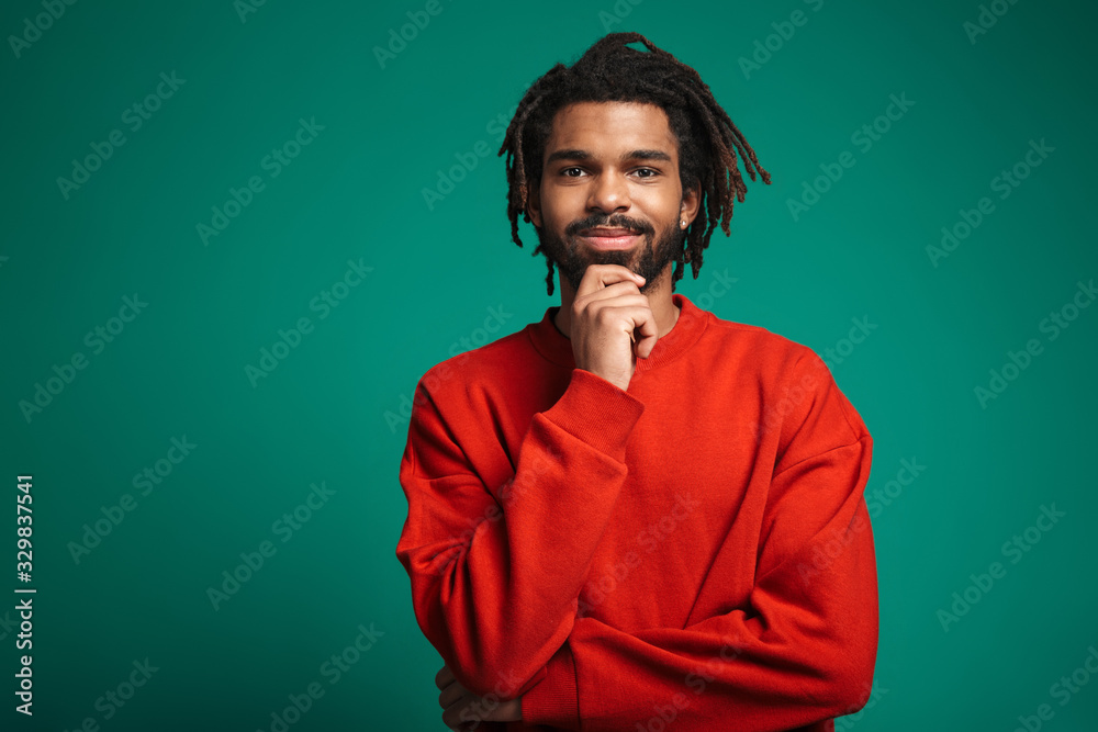 Portrait of pleased african american man smiling and looking at camera Portrait of pleased african american man smiling and looking at camera