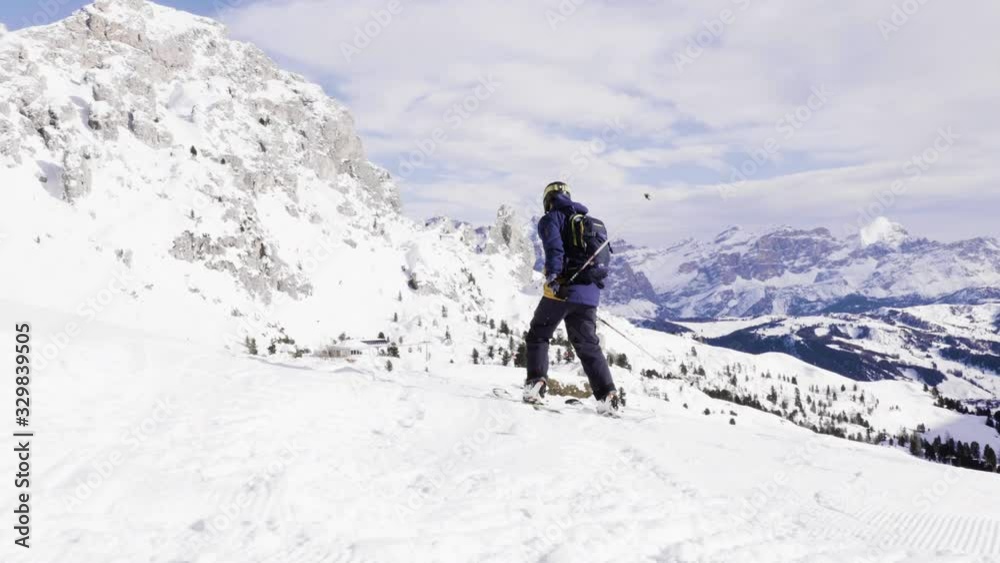 FOLLOW CLOSE UP: Happy skier having fun skiing backcountry on a sunny winter day in snowy mountains. Extreme freeride skier riding fresh powder snow off piste in mountain ski resort in dolomites Italy FOLLOW CLOSE UP: Happy skier having fun skiing backcountry on a sunny winter day in snowy mountains. Extreme freeride skier riding fresh powder snow off piste in mountain ski resort in dolomites Italy
