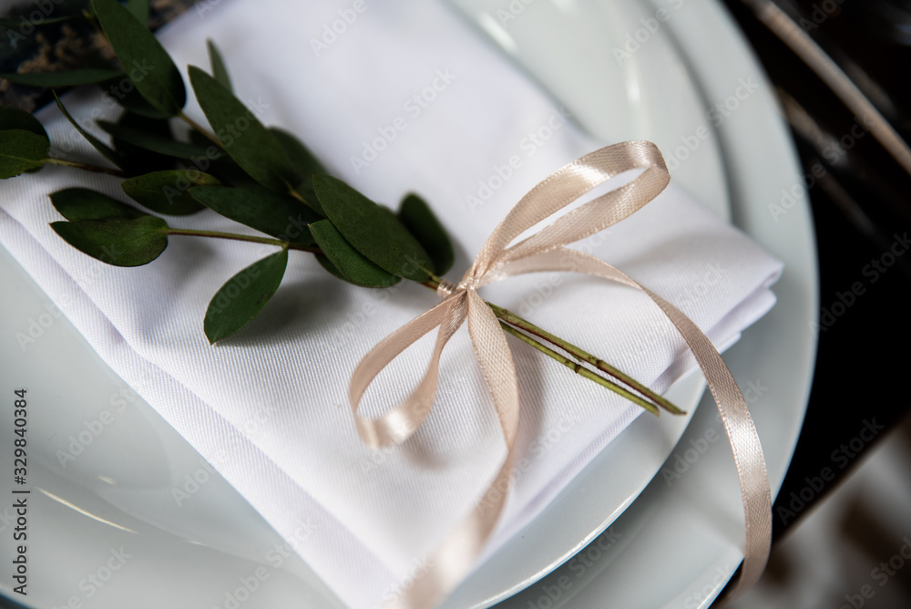 The decor on the plate is a branch of eucalyptus The decor on the plate is a branch of eucalyptus