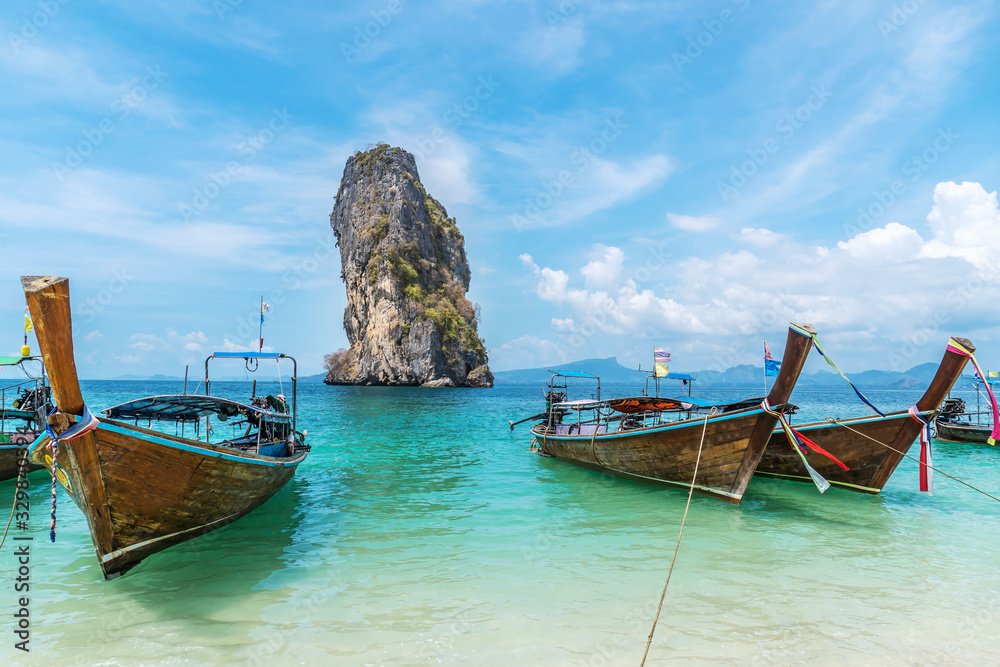 Thai traditional wooden longtail boat and beautiful sand beach at Koh Poda island in Krabi province. Ao Nang, Thailand ,Krabi island is a most popular tourist destination in Thailand Thai traditional wooden longtail boat and beautiful sand beach at Koh Poda island in Krabi province. Ao Nang, Thailand ,Krabi island is a most popular tourist destination in Thailand