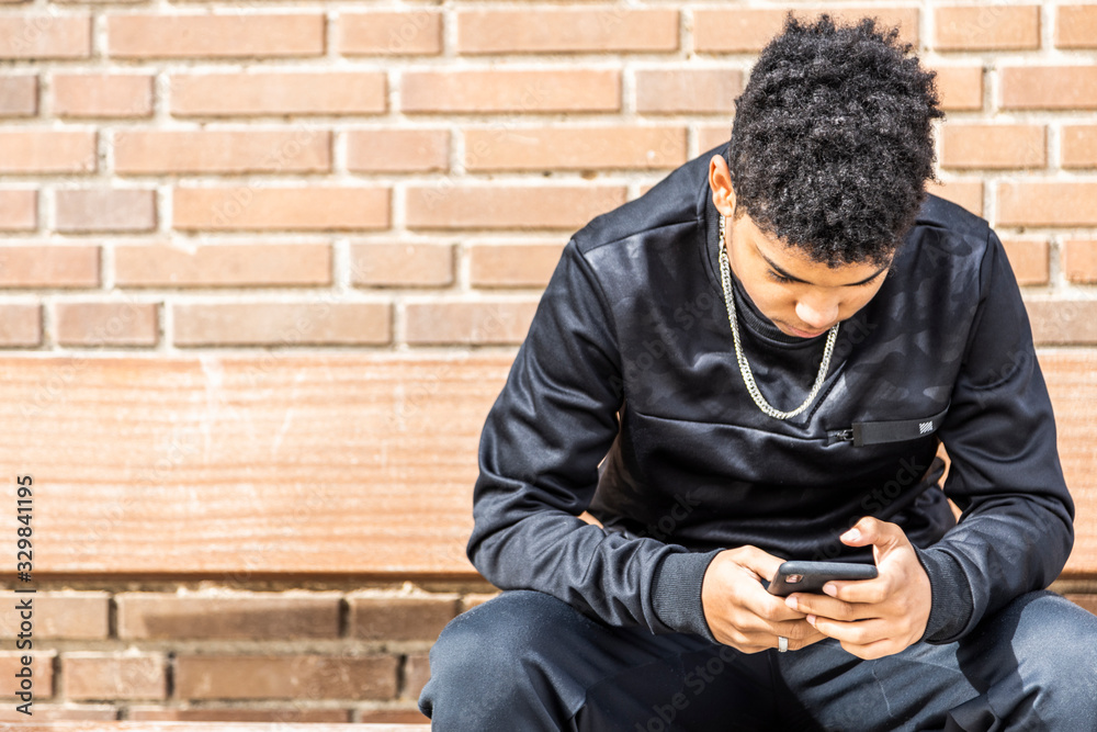 Afro boy with his smart phone Afro boy with his smart phone