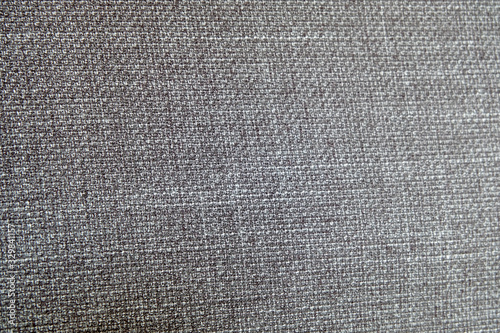 Selective focus, Close up shot of dark grey formal suit cloth textile surface. wool fabric texture for important luxury evening or night event. Wallpaper and background with copy space for text