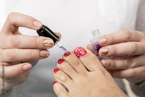 Pedicure Master does the procedure to the client