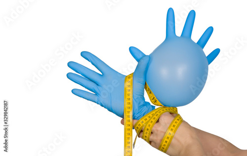 Lymphedema: Symptoms, treatments, and causes concept - Hand putting on blue glove, isolated on white background photo