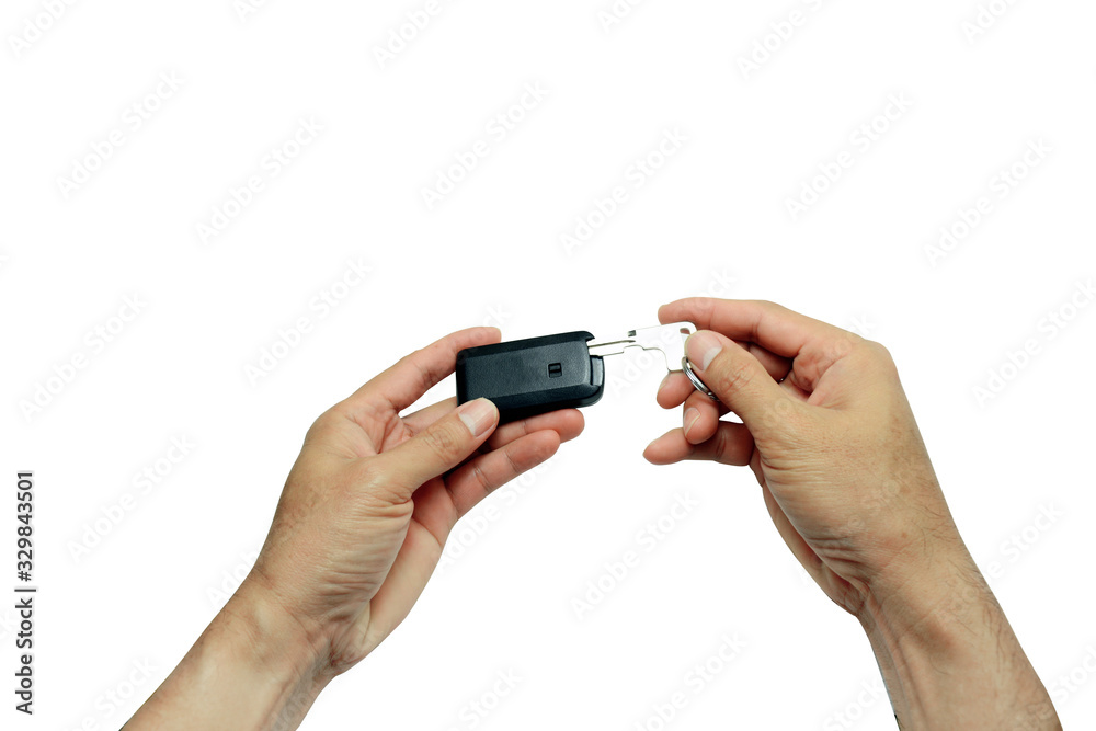 adult hand pulling a car key from slot in remote body on white background isolated with clipping path adult hand pulling a car key from slot in remote body on white background isolated with clipping path