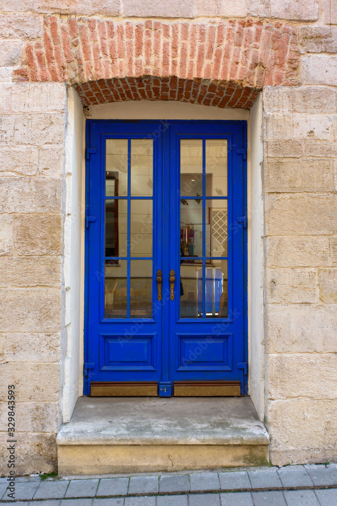Fototapeta premium Blue door with brick wall at Lviv, Ukraine.