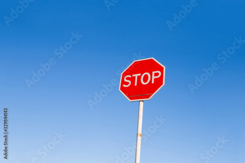 Stop sign against a blue sky. Danger warning.