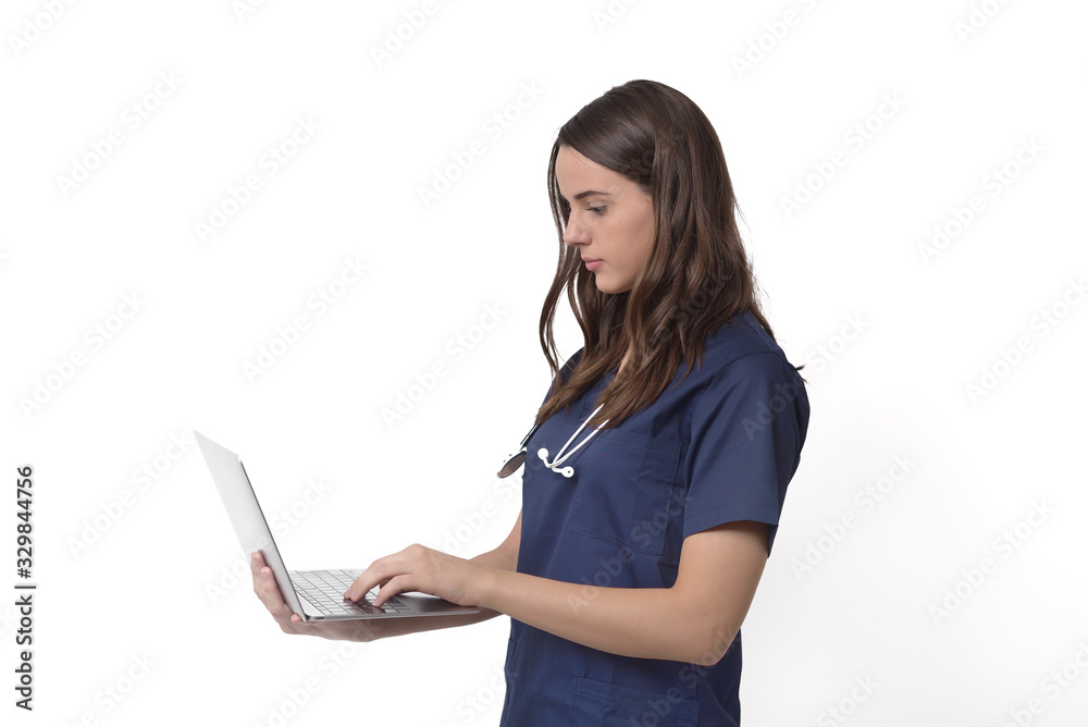 Young female doctor with stethoscope over neck working on laptop, isolated on white Young female doctor with stethoscope over neck working on laptop, isolated on white