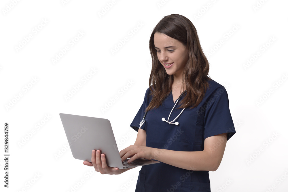 Young female doctor with stethoscope over neck working on laptop, isolated on white Young female doctor with stethoscope over neck working on laptop, isolated on white