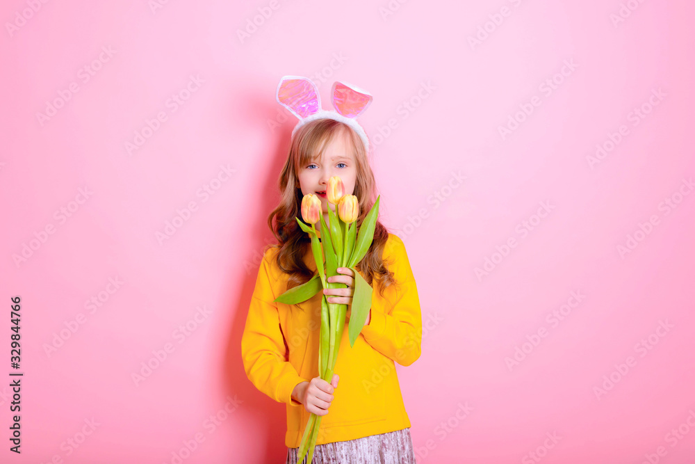 Happy Easter! Beautiful girl baby blonde in rabbit ears holding yellow tulips. Happy mother 's Day! international women day. Daughter's day. Traditions, holidays, religion, sale, Black Friday concept. Happy Easter! Beautiful girl baby blonde in rabbit ears holding yellow tulips. Happy mother 's Day! international women day. Daughter's day. Traditions, holidays, religion, sale, Black Friday concept.