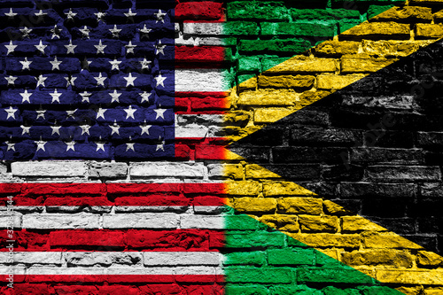 Flag of the United States of America and Jamaica on brick wall