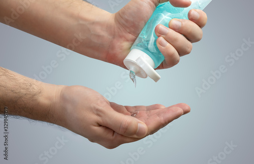 Person applying hand sanitiser gel to kill bacteria and disease - Close up of hands washing and cleansing with hygienic soap sanitizer - Hygiene and cleaning, Antibacterial and Coronavirus concept