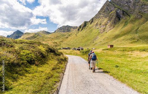 The people are trekking on the Piora Valley in Switzerland. © EleSi