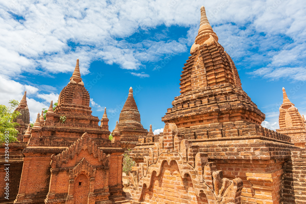 Buddhist pagoda temple. Bagan, Myanmar. Home of the largest and denset concentration of religion Buddhist temples, pagodas, stupas and ruins in the world. Blue sky with clouds.