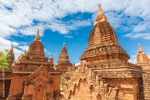 Buddhist pagoda temple. Bagan, Myanmar. Home of the largest and denset concentration of religion Buddhist temples, pagodas, stupas and ruins in the world. Blue sky with clouds.