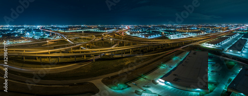 Aerial picture of highway intersection at night near Fort Worth in Texas with lightspurs