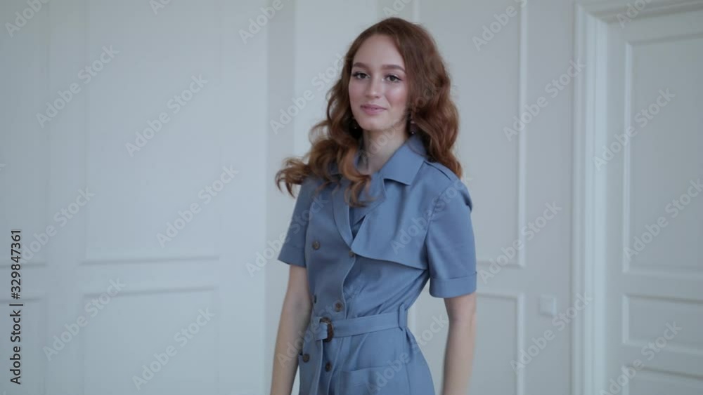 girl with red hair wearing a beautiful dress, white wall background girl with red hair wearing a beautiful dress, white wall background