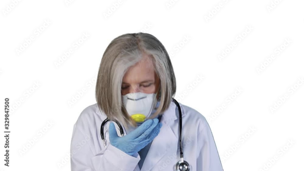 A doctor coughs protected by an anti-virus mask. A doctor coughs protected by an anti-virus mask.