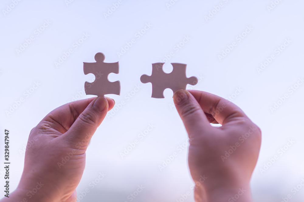 Closeup hands, connected hands, puzzle, support teamwork with sunshine, business vitality, success and strategic thinking. Closeup hands, connected hands, puzzle, support teamwork with sunshine, business vitality, success and strategic thinking.