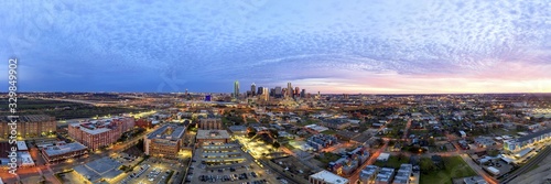 Panoramic picture of the Dallas skyline in morning sun and cloudy sky