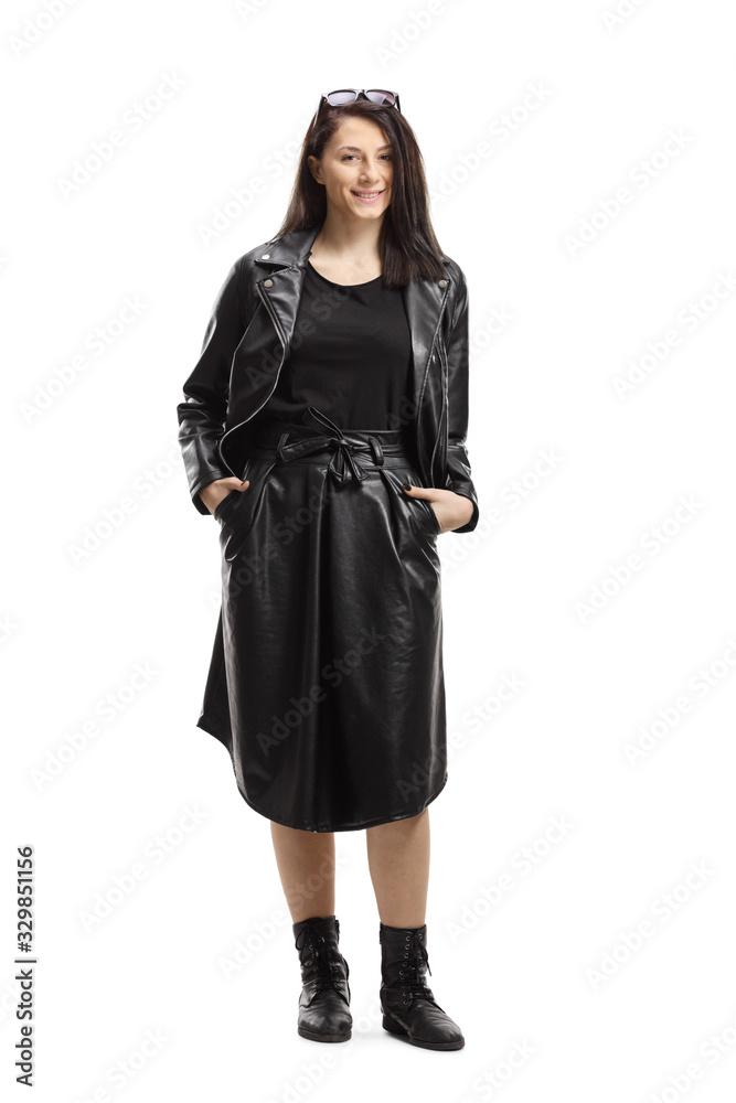 Young woman wearing leather jacket and skirt and smiling at the camera Young woman wearing leather jacket and skirt and smiling at the camera