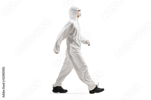 Canvas Print Man wearing a protective suit and mask and walking