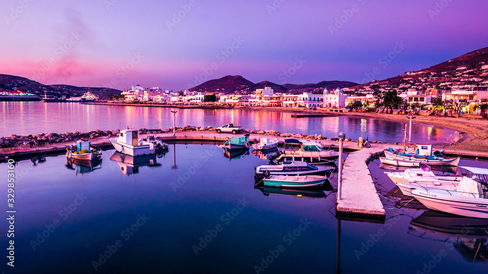 Small pier with various fishermans boats at sunset