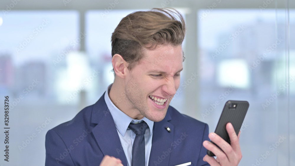 Portrait of Sad Young Businessman getting Loss on Smartphone Portrait of Sad Young Businessman getting Loss on Smartphone
