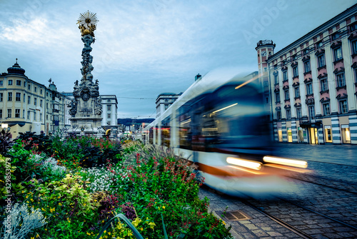 Obraz na plátně Trinity Column with flowerbed and tramway in Linz, Austria